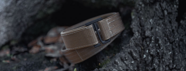 Product photography of Vedder Holsters the best gun belt in the market, the V3 Belt placed next to a tree trunk.