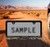 Black Plastic License Frame with 3D Bronco Script Emblem _  Cracked Ground design
