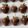 Freshly Coated Strawberries Coated In Premise Maid's Signature Dark Chocolate Before Being Fully Covered In Chocolate