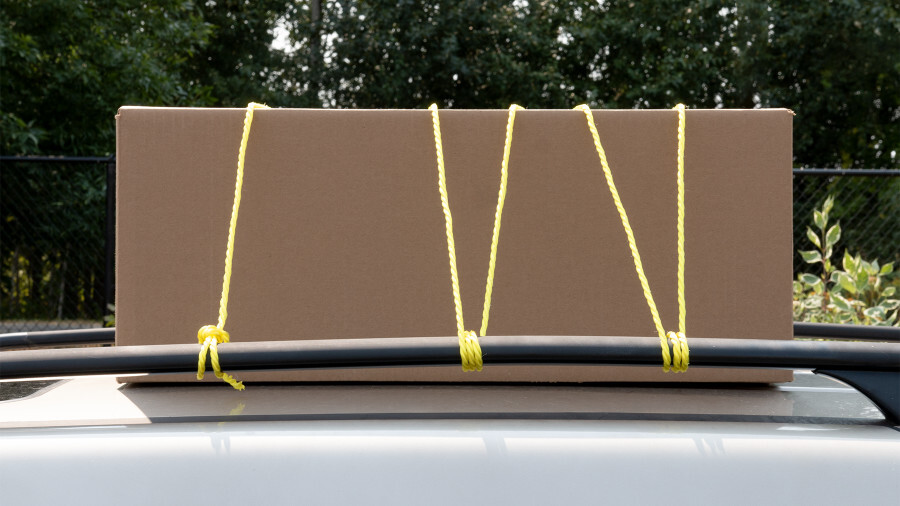 Performance Tool Cargo Control, featuring polypropylene rope being used to hold down cargo on top of a vehicle.