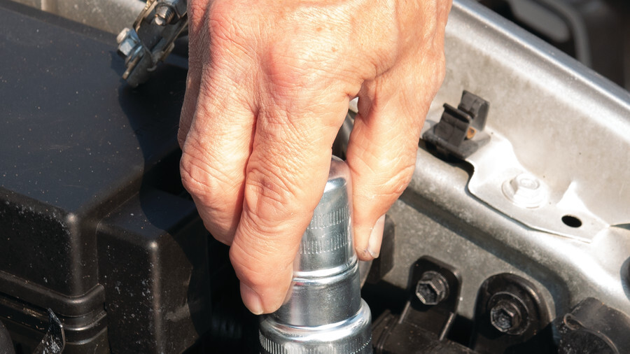 Performance Tool Battery Cleaning Tools, featuring a battery post brush being used on a battery.