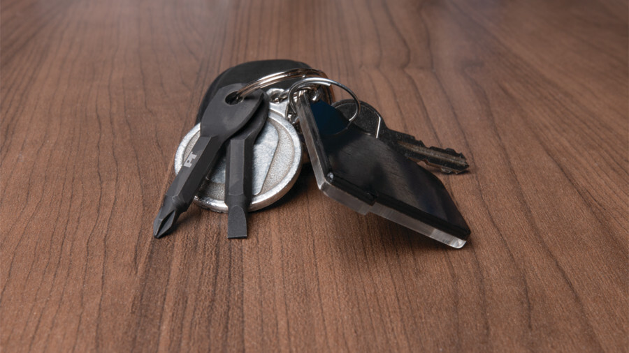 Performance Tool keychains and holders featuring an image of keys on a wooden table