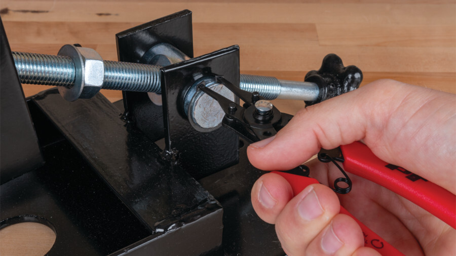 Performance Tool pliers featuring an image of snap ring pliers being used to remove a snap ring