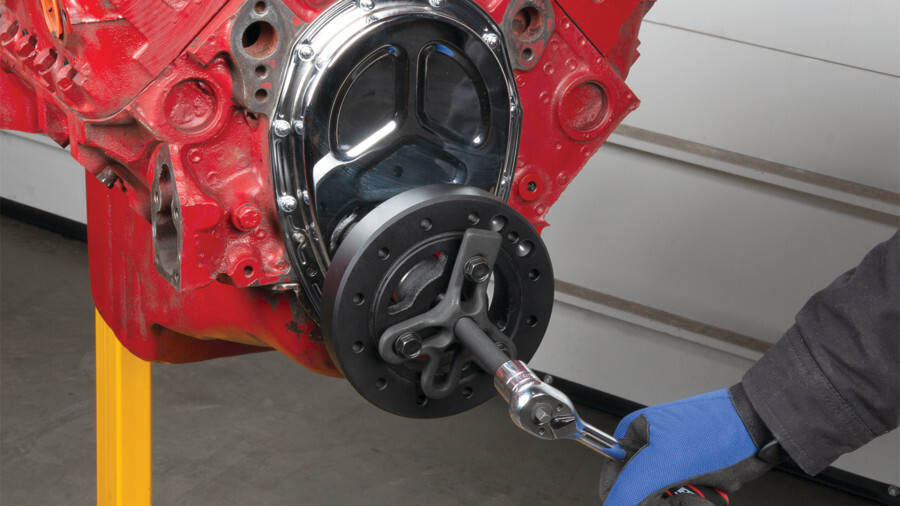 Performance Tool crankshaft tools. Features and image of a harmonic balancer puller in use. 