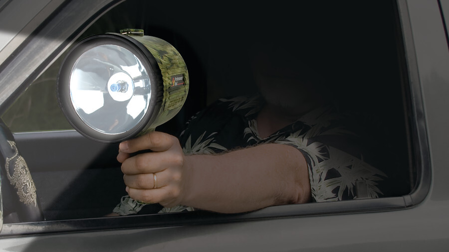Performance Tool spotlights featuring an image of a man in a vehicle shining his pistol grip spotlight toward the camera