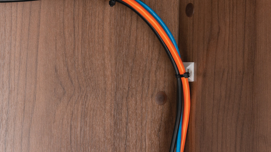Performance Tool cable ties featuring an image of a wall mount cable tie holding a pair of cat-5e cables