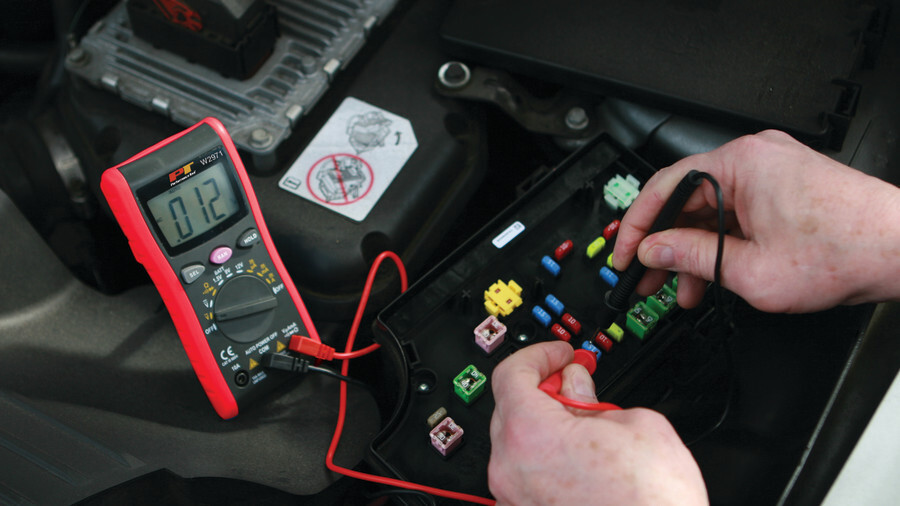 Performance Tool multimeters featuring a red multimeter probing fuses