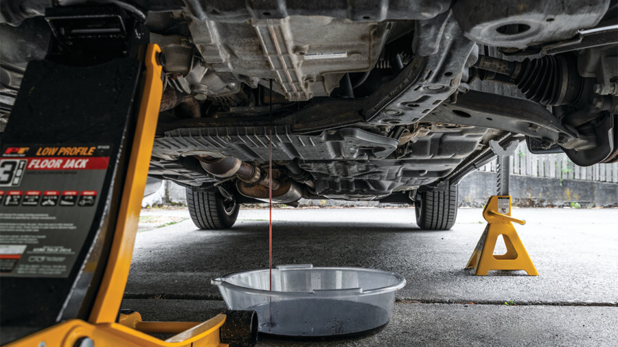 Performance Tool Jack Stands, featuring a vehicle being drained of oil. 