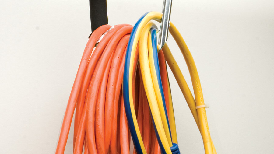 Performance Tool carabiners for securing cargo. Featuring an image of a carabiner holding a number of wires on a rack.