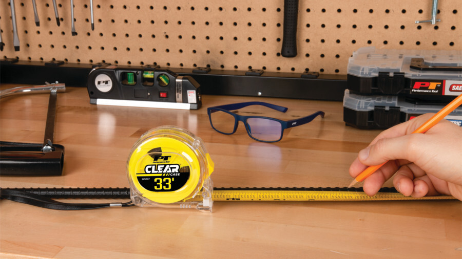 Performance Tool measuring and layout tools featuring a clear branded tape measurer on a work table