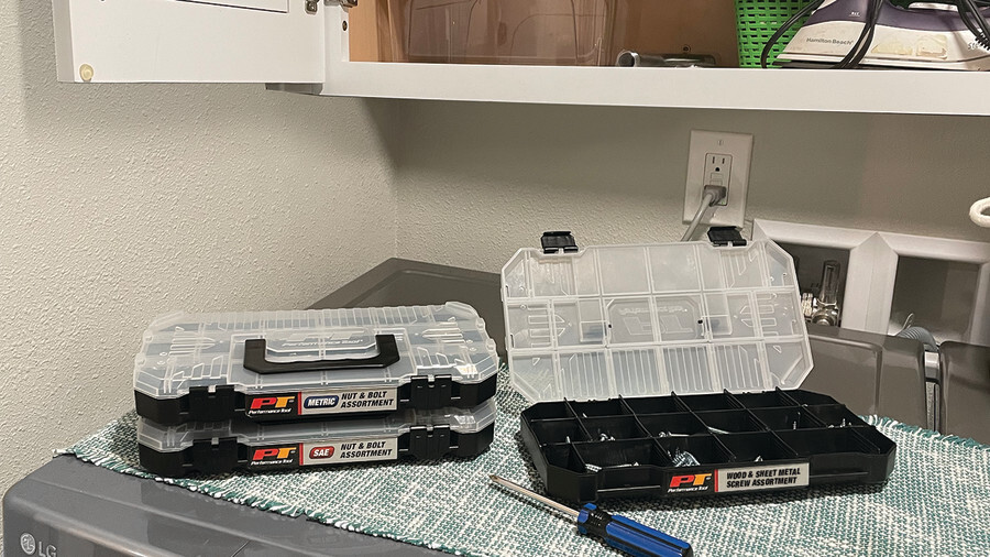 Performance Tool Bolts Nuts and Washers, featuring a general purpose stacking hardware kit on a washing machine with a screwdriver.