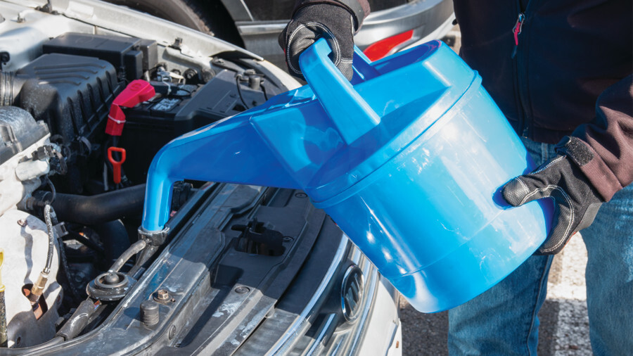 Performance Tool cooling accessories. Featuring an image of a Plastic Radiator Filler in use filling a radiator outside.