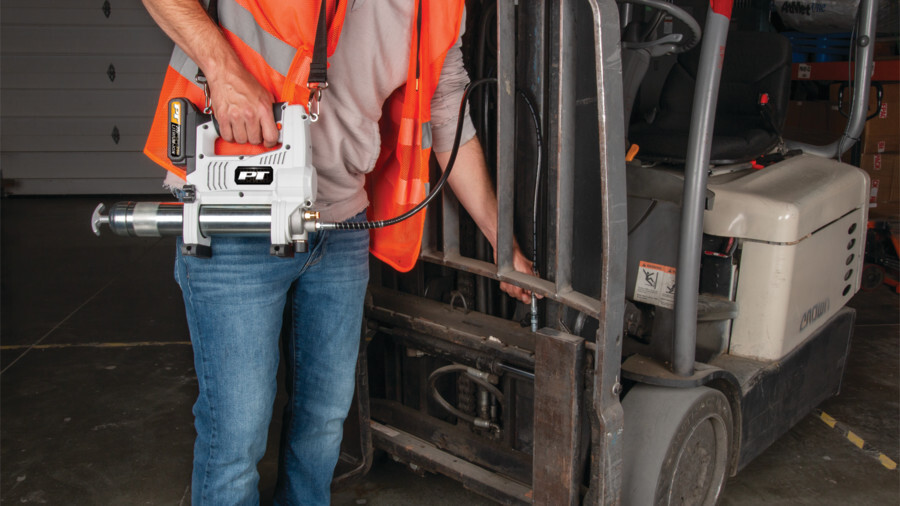 Performance Tool grease guns featuring an image of a worker in a safety vest using a 12v Grease gun to lubricate a fork lift.