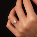 Oval Cut Birthstone Opal Engagement Ring in Gold on female model
