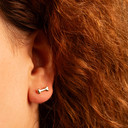 Yellow Gold Dog Bone Stud Earrings on female model