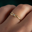 14K Yellow Gold CZ Bow Tie Ribbon Band Ring on female model