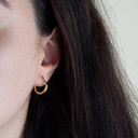 14K Yellow Gold Reversible Striped Hoop Earrings on female model