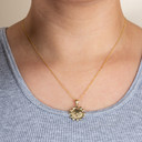 Gold Celestial Sun Face Pendant Necklace on female model