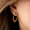 14K Yellow Gold Reversible Diamond Cut Ribbed Hoop Earrings on female model