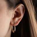 Yellow Gold Flat Wide Hoop Earrings on female model