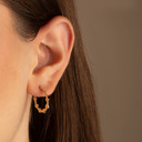 Yellow Gold Polished Ribbed Hoop Earrings on female model