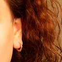 Two-Tone Gold Heart Huggie Hoop Earrings on female model
