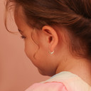 Two-Tone Gold Heart Ribbed Huggie Hoop Baby Earrings on model
