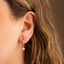 Yellow Gold Pearl Drop Huggie Earrings on female model