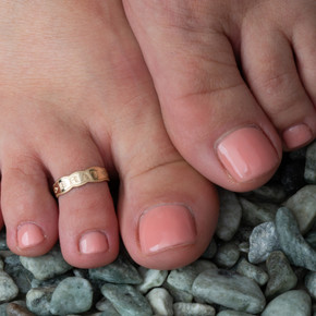 Gold Woman's Youthful Brat Toe Ring on female model