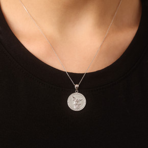 Silver Saint Michael Pendant Necklace with Cubic Zirconia on female model Silver Saint Michael Pendant Necklace with Cubic Zirconia on female model