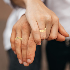 Gold Trinity Knot His and Hers Ring on male and female model