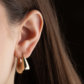 Yellow Gold Purse Hoop Earrings on female model