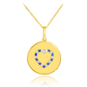 Heart disc pendant necklace with diamonds and sapphire in 14k gold.