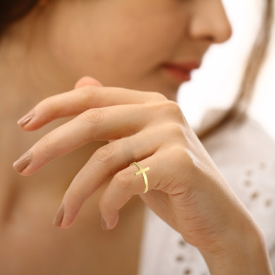 Gold Sideways Cross Band Ring on a female model
