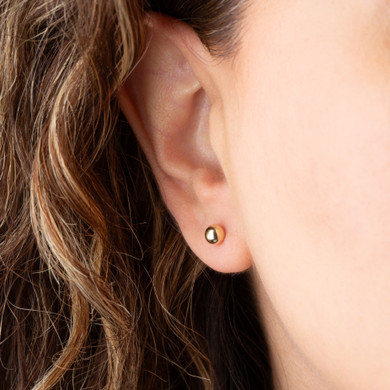 Yellow Gold Ball Stud Earrings Small on female model