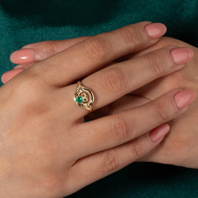 Gold Woman's Alluring Emerald Claddagh Ring on female model