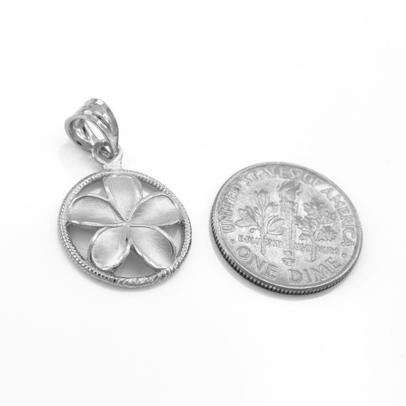 .925 Sterling Silver Hawaiian Plumeria Flower Circle Rope Pendant next to a quarter