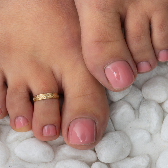 Gold Woman's Flower Power Toe Ring on female model