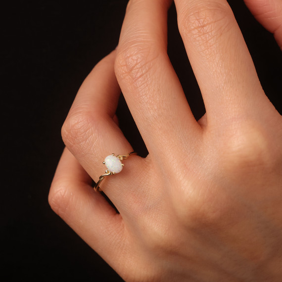 Oval Cut Birthstone Opal Engagement Ring in Gold on female model