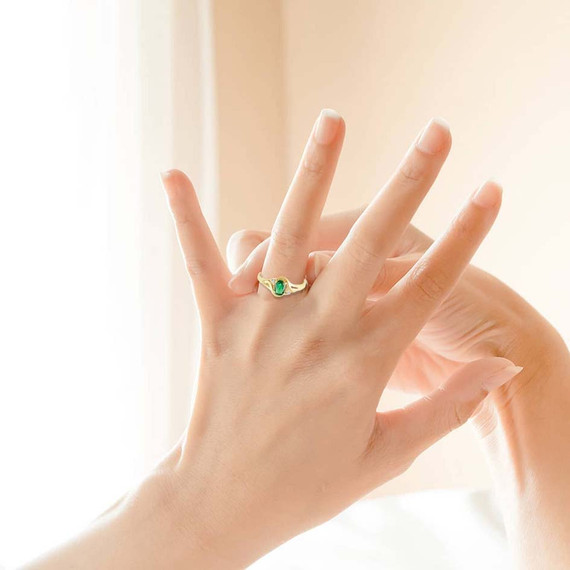 Yellow Gold Emerald Oval Cut Gemstone & CZ Women's Ring on female model