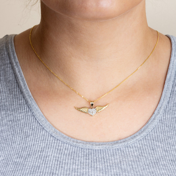 Gold Diamond Studded Winged Angel Heart Pendant Necklace on female model