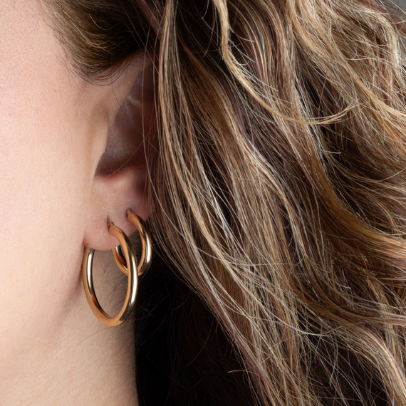 14K Gold Tube Hoop Earrings on female model