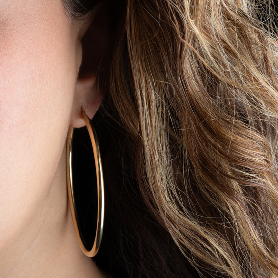 14K Gold Tube Hoop Earrings on female model
