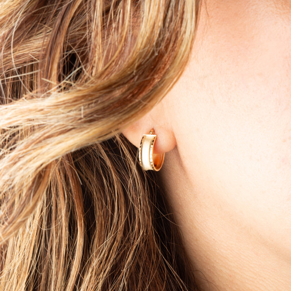 14K Yellow Gold Satin Finish Huggies Hoop Diamond Cut Earrings on female model