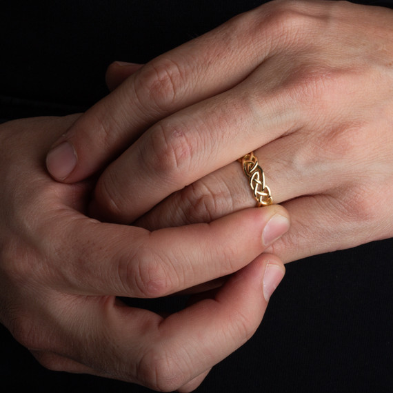 Gold Unisex Irish Celtic Trinity Knot Eternity Wedding Band Ring on male model