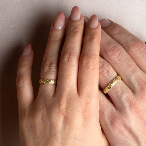 Yellow Gold Irish Celtic Trinity Knot Eternity Unisex Band Ring Set on male and female model