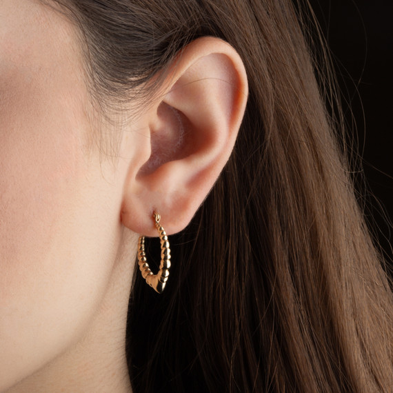 Yellow Gold Heart Love Hoop Earrings on female model