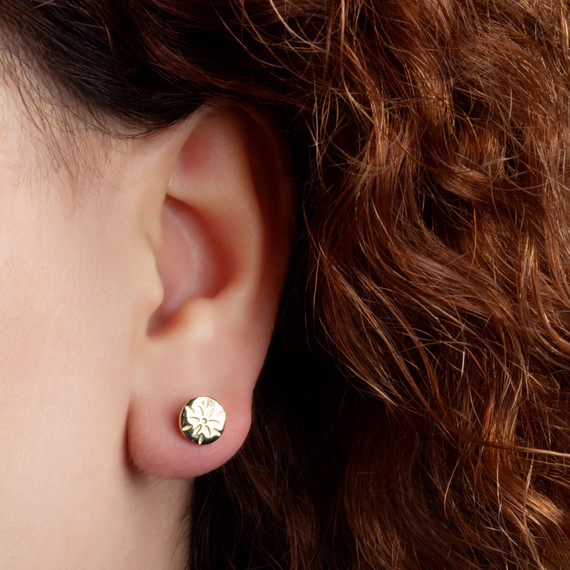 Yellow Gold Flower Textured Diamond Cut Round Stud Earrings on female model