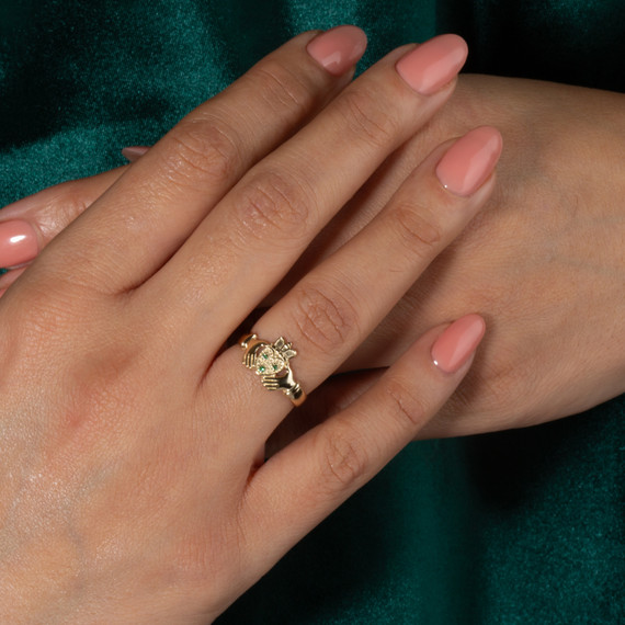 Yellow Gold Woman's Elegant Emerald Claddagh Ring on female model