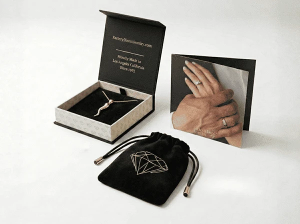 Factory Direct Jewelry signature packaging — black gift box, velvet pouch, and authenticity card
